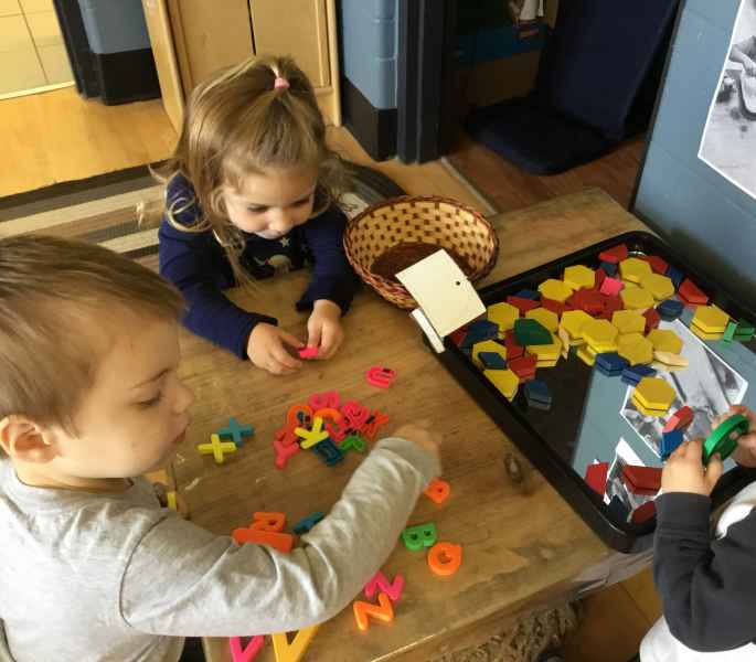 children playing with shapes and numbers